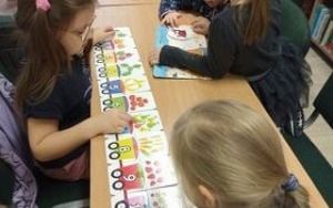 Dzieci układające puzzle w formie wagonów